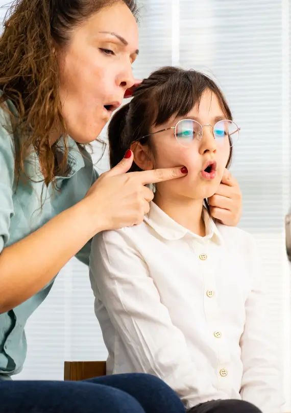 Professional speech therapist helping a kid